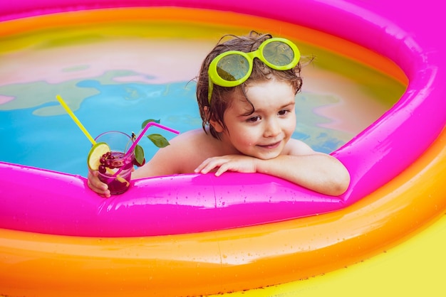 Niño niño divirtiéndose en la piscina niño lindo relajante en la piscina niños jugando en la piscina ...