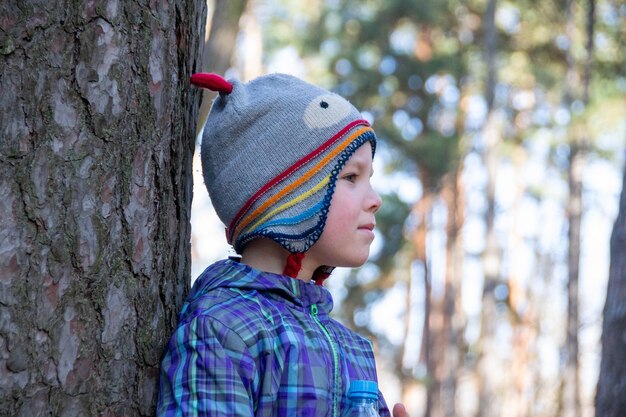 El niño pasa un tiempo feliz al aire libre en el bosque disfrutando de la naturaleza de otoño