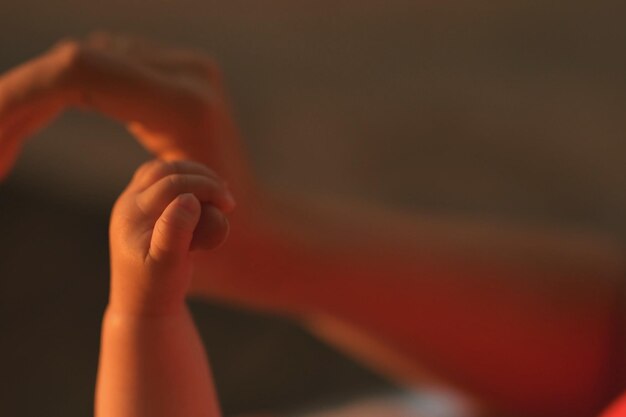 Niño recortado sosteniendo la mano de la madre