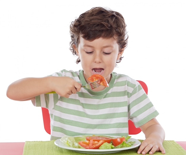 Niño sano comiendo una dieta balanceada sobre fondo