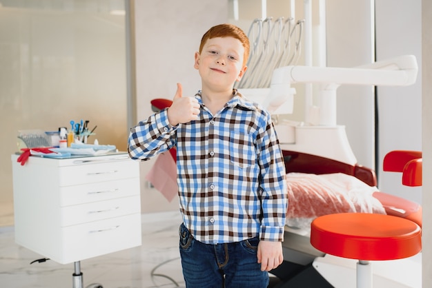 Niño satisfecho con el servicio en el consultorio dental. concepto de tratamiento dental pediátrico