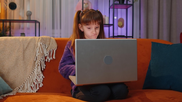 Niño usando una computadora portátil en casa