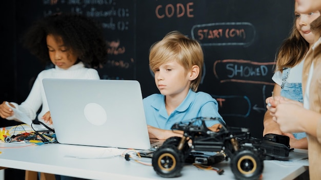 Foto niño usando una computadora portátil programando código de ingeniería y escribiendo programas de erudición