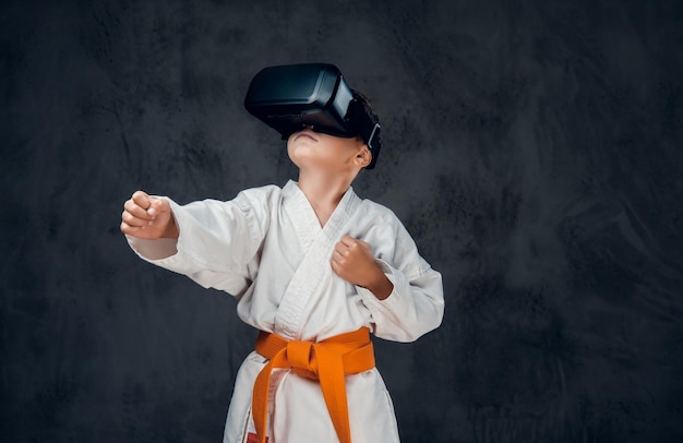 Niño vestido con un kimono blanco con gafas VR en la cabeza.