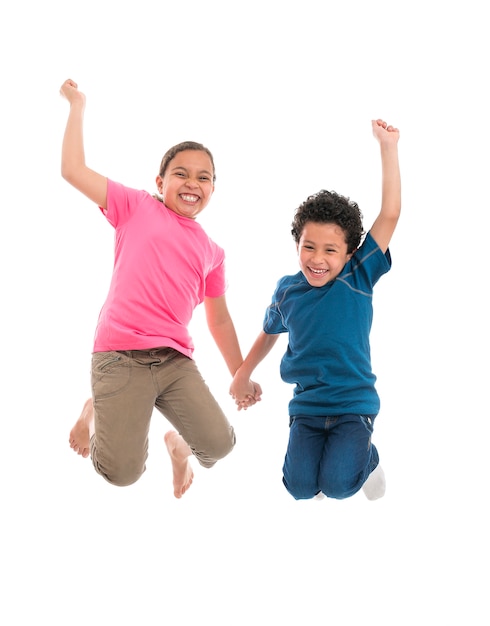 Niños alegres activos saltando con alegría aislado sobre fondo blanco.