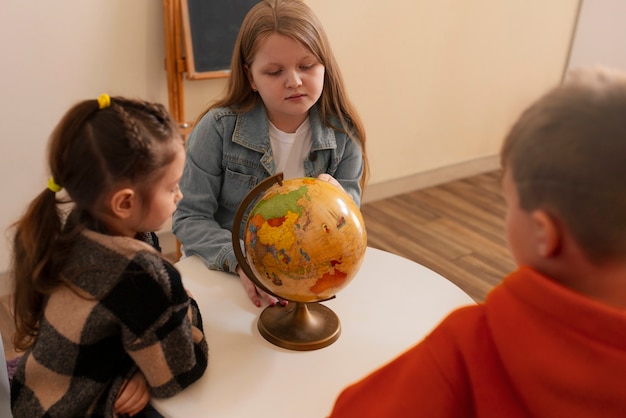 Niños de alto ángulo aprendiendo en la escuela.