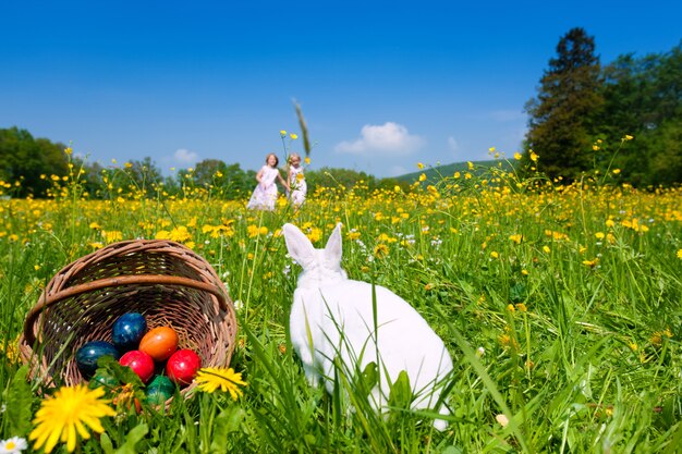 Niños en búsqueda de huevos de Pascua con conejito