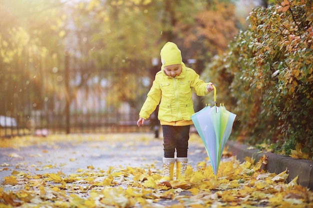 Los niños caminan en el parque de otoño en el otoño.