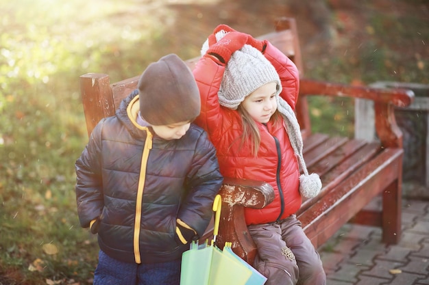 Los niños caminan en el parque de otoño en el otoño.