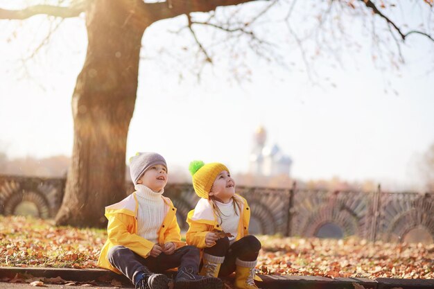 Los niños caminan en el parque de otoño.