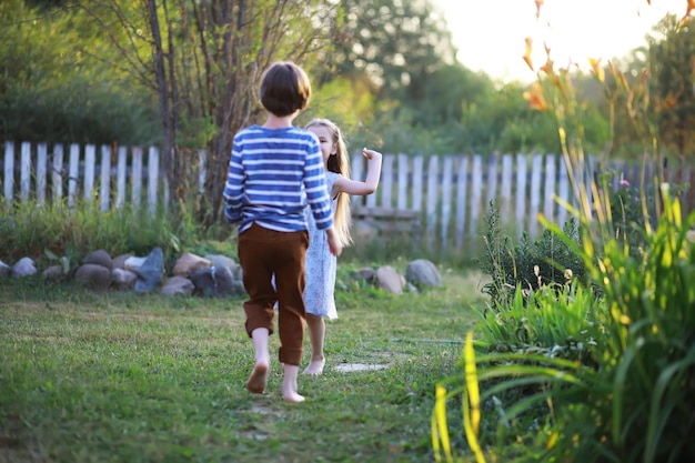 Los niños caminan en verano en la naturaleza Niño en una soleada mañana de primavera en el parque Viajar con niños
