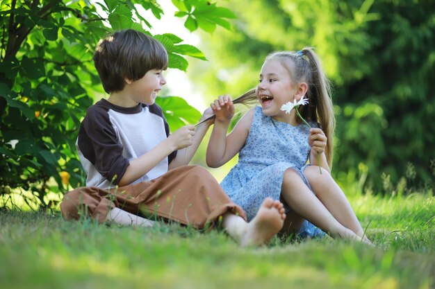 Los niños caminan en verano en la naturaleza Niño en una soleada mañana de primavera en el parque Viajar con niños