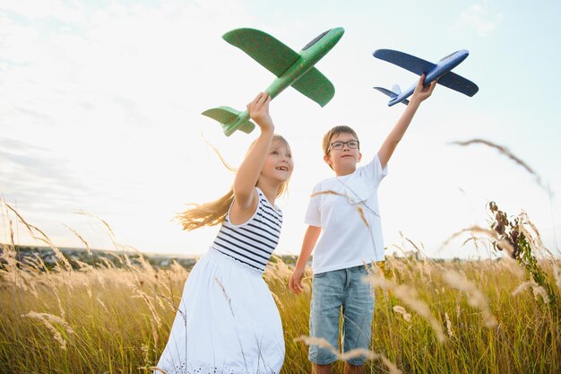 Niños corriendo activos con un niño con un juguete de avión