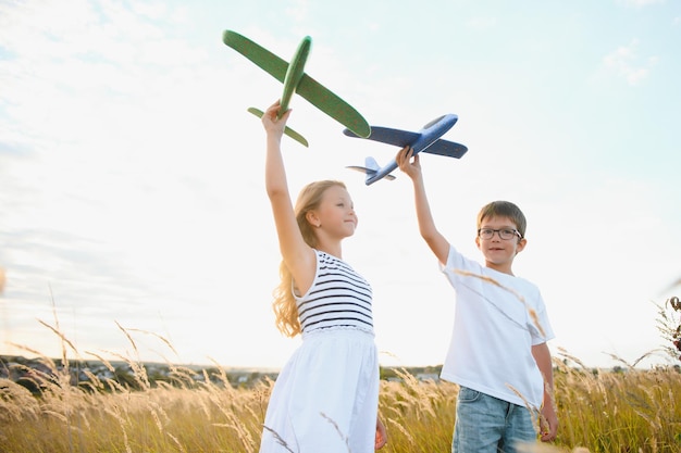 Niños corriendo activos con un niño con un juguete de avión