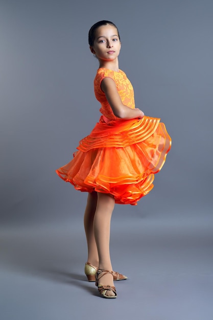 Niños deporte bailando niño niña en vestido deportivo naranja posando
