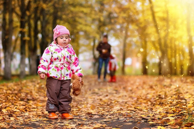 Niños divirtiéndose en un paseo por el parque de otoño.