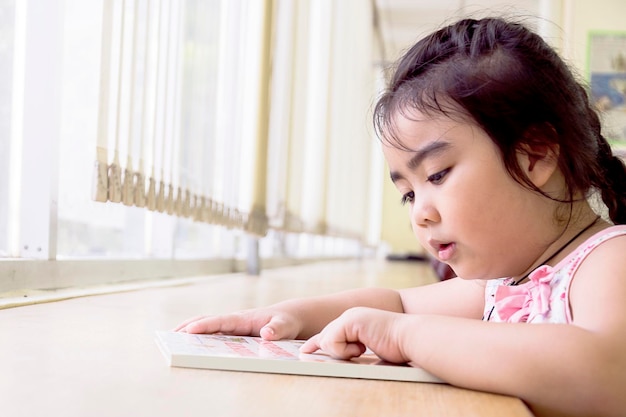 Los niños están leyendo libros en la biblioteca. Leer es la mejor manera de aprender. Mejora el conocimiento y la imaginación. El gran libro amarillo que está leyendo. Un buen futuro te está esperando.