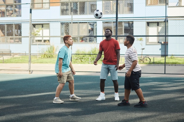 Niños jugando al fútbol en el patio de recreo