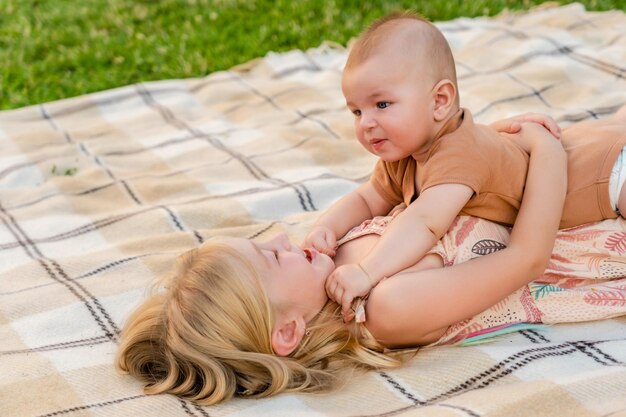 Niños lindos acostados en una manta en verano