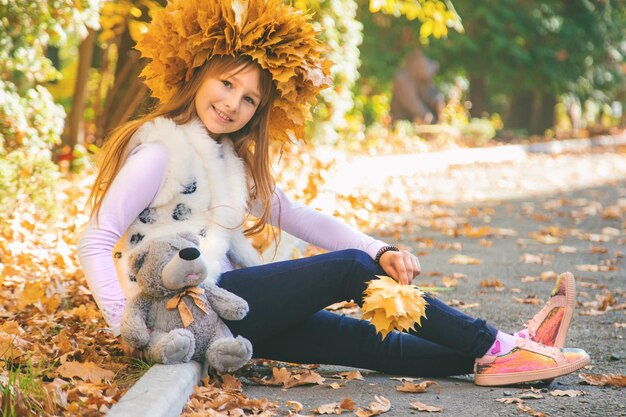 Niños en el parque con hojas de otoño Enfoque selectivo