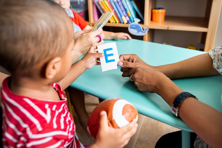 Foto niños pequeños aprendiendo el alfabeto inglés con sus padres.