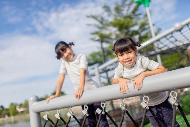 Niños pequeños escalando en el patio de la escuela