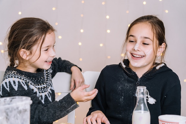 Niños pequeños hornear galletas de jengibre en la cocina de la casa el día de invierno. Niños jugando con harina.