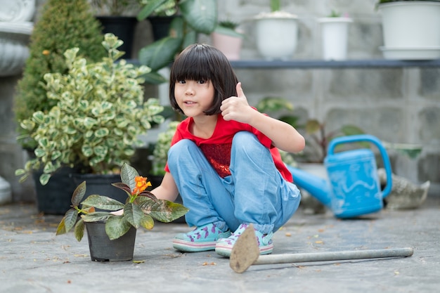 Niños plantando árboles con fondo de naturaleza, niña asiática feliz