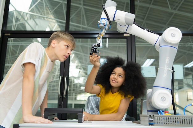 Foto los niños que usan la tecnología del robot de mano los estudiantes están estudiando tecnología que es una de las stem