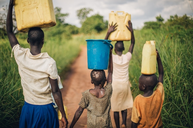 Niños en Uganda caminan por el agua