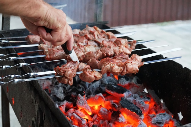 No churrasco de verão é cozido na grelha. carne no espeto. a fumaça do carvão.