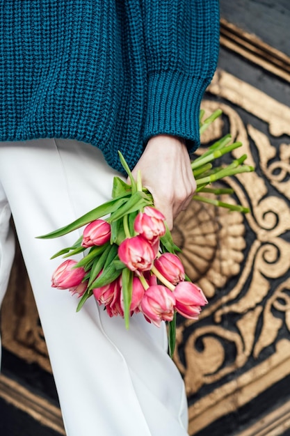 No hay rostro de close up de tulipanes rosados flores ramo en la mano de la mujer al aire libre mujer irreconocible sosteniendo en las manos un ramo de tulipas rosadas