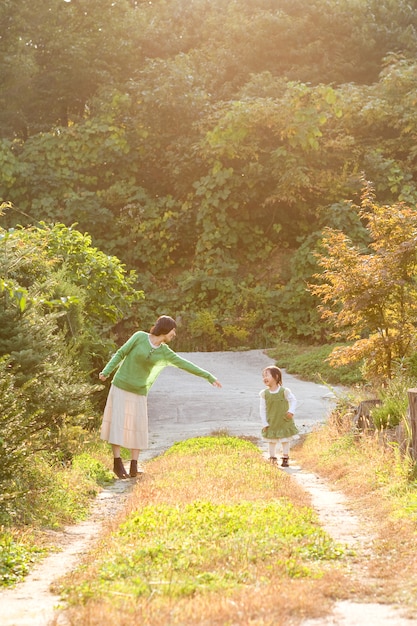 No parque ao pôr do sol, a mãe e a criança se divertem.