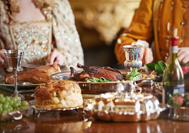 La nobleza festeja mientras la gente pasa hambre Captura recortada de una pareja noble comiendo juntos en el comedor del palacio