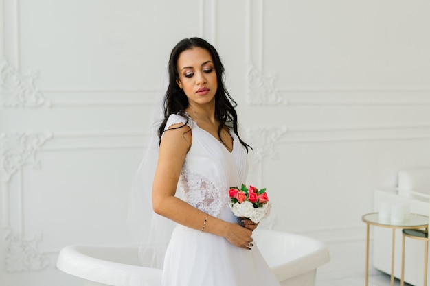 Noiva afro-americana com vestido de manhã se preparando para o casamento em um quarto de hotel