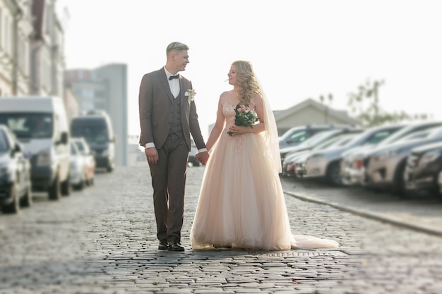 Noiva e noivo andando na rua da cidade. foto com espaço de cópia