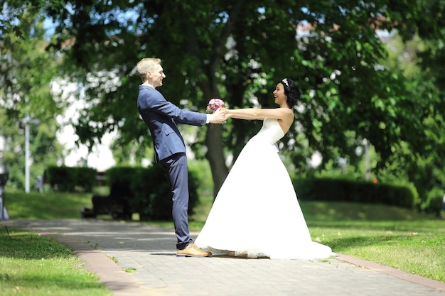 Noiva e noivo circulando no parque