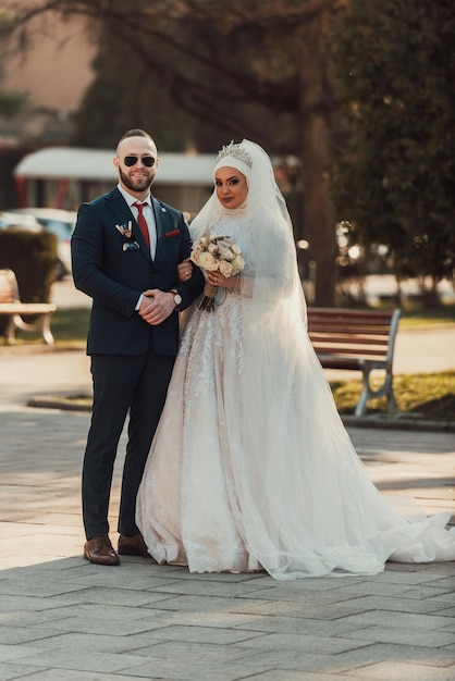 Noiva e noivo em um parque se beijando Casal recém-casados noiva e noivo em um casamento na natureza floresta verde estão se beijando retrato fotográficoCasal de casamento