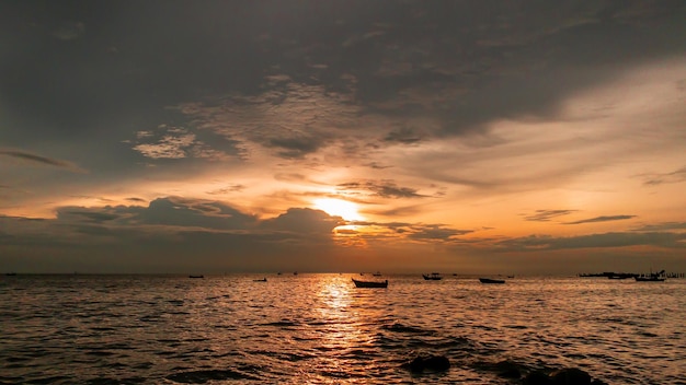 Para noma vista del atardecer en el mar barco de pesca en el mar