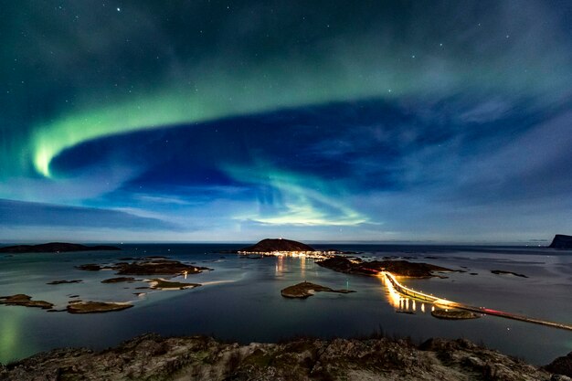 Foto nordlichter aurora borealis am nachthimmel über der berühmten sommaroy-brücke