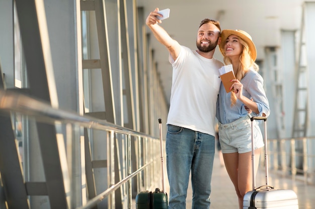 Nos encanta viajar Pareja amorosa haciendo selfie en el aeropuerto