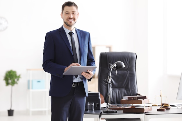 Foto notario masculino joven con tableta en la oficina