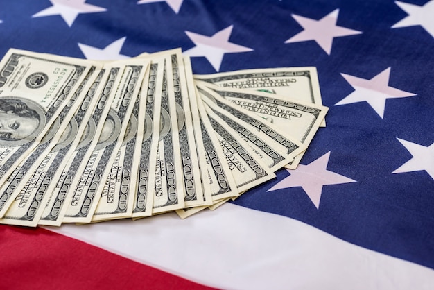 Notas de dólar na bandeira americana fecham