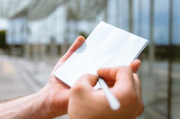 Notizbuch in der Hand eines Mannes