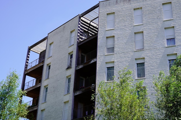 Nova arquitetura de varanda exterior de prédio de apartamentos brancos de fachada moderna no céu azul de verão