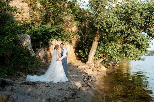 Novia chica rubia y novio cerca del río