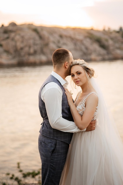 Novia chica rubia y novio cerca del río