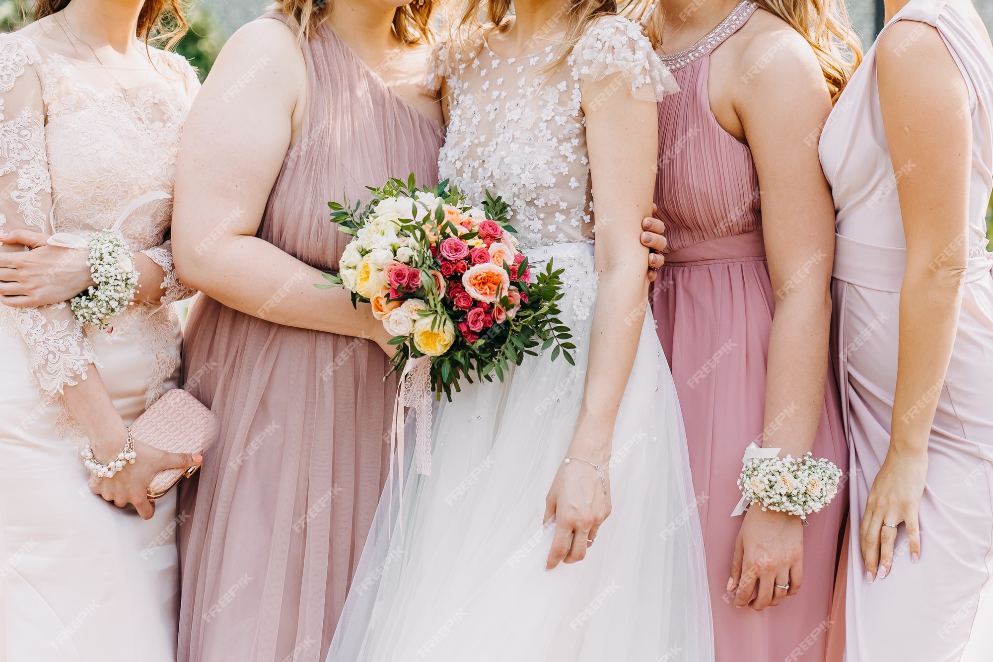 La novia y las de honor con vestidos maxi de tul en tonos rosa pastel | Foto