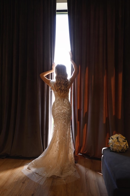 Novia mirando por la ventana en una boda