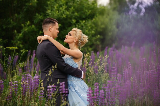 Novia y el novio abrazando en campo de lavanda